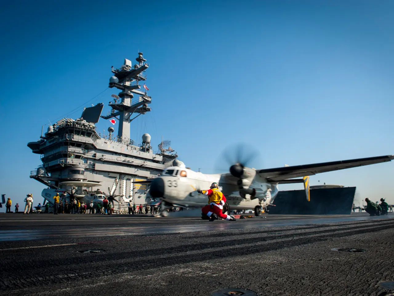 In the image there is an airplane going on runway with a person running in front of it and in the...