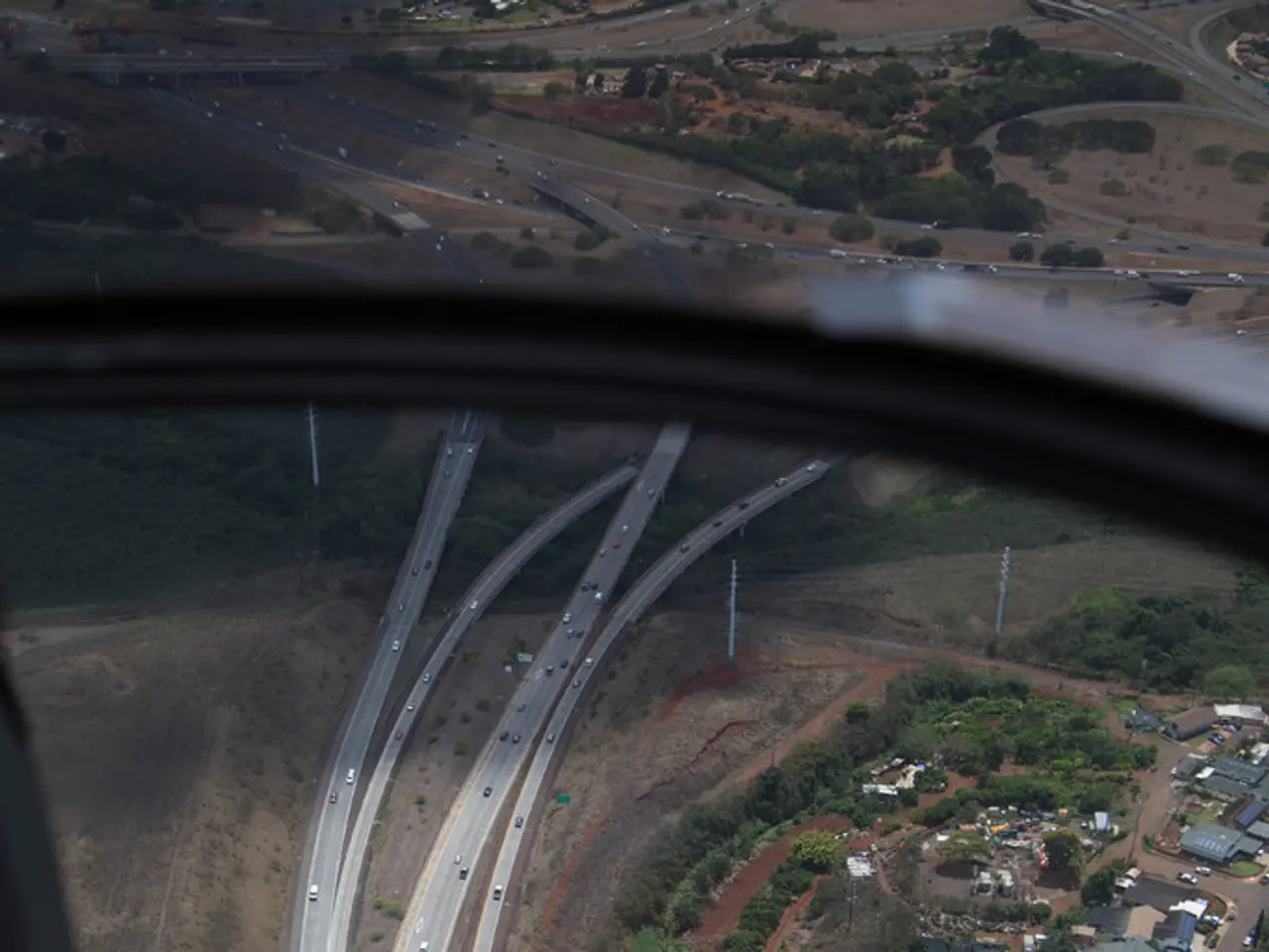 This image is taken from inside the airplane. In this image we can see there is a glass of an...