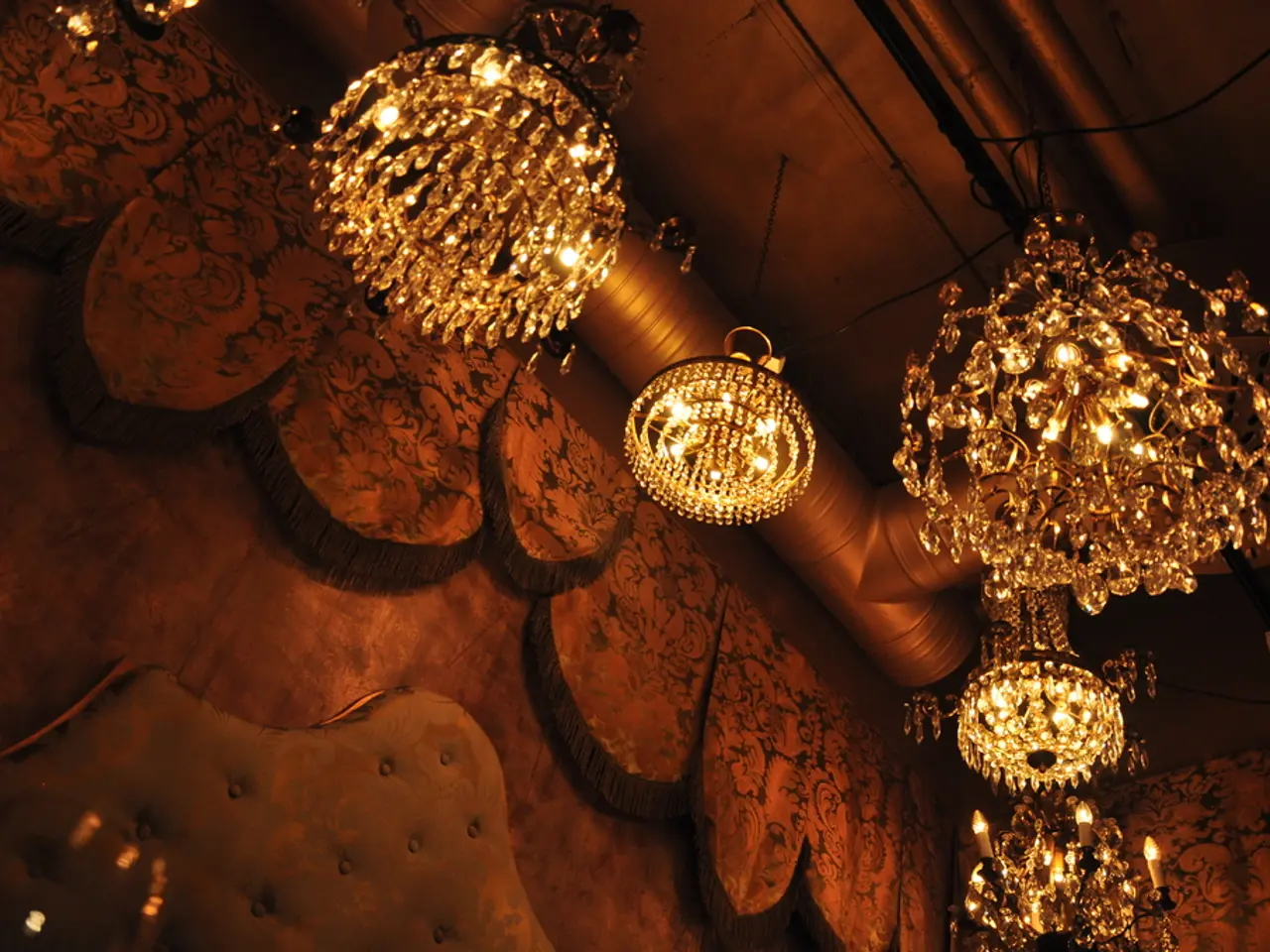 In this image we can see ceiling lights, wall, decorative items, pipe, and poles.