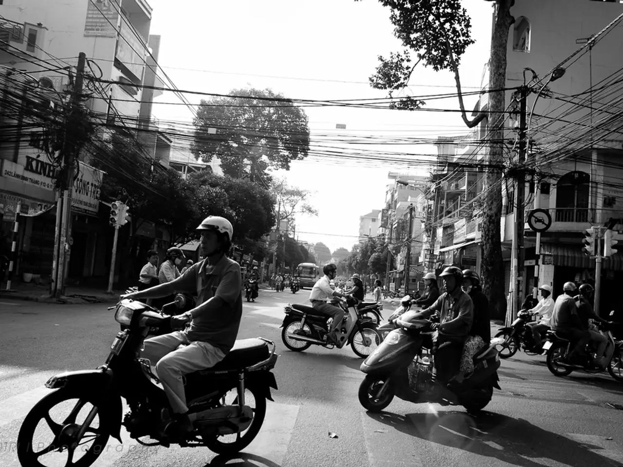 On a road there are few people riding on bike and and there is a bus on road. On the other side...