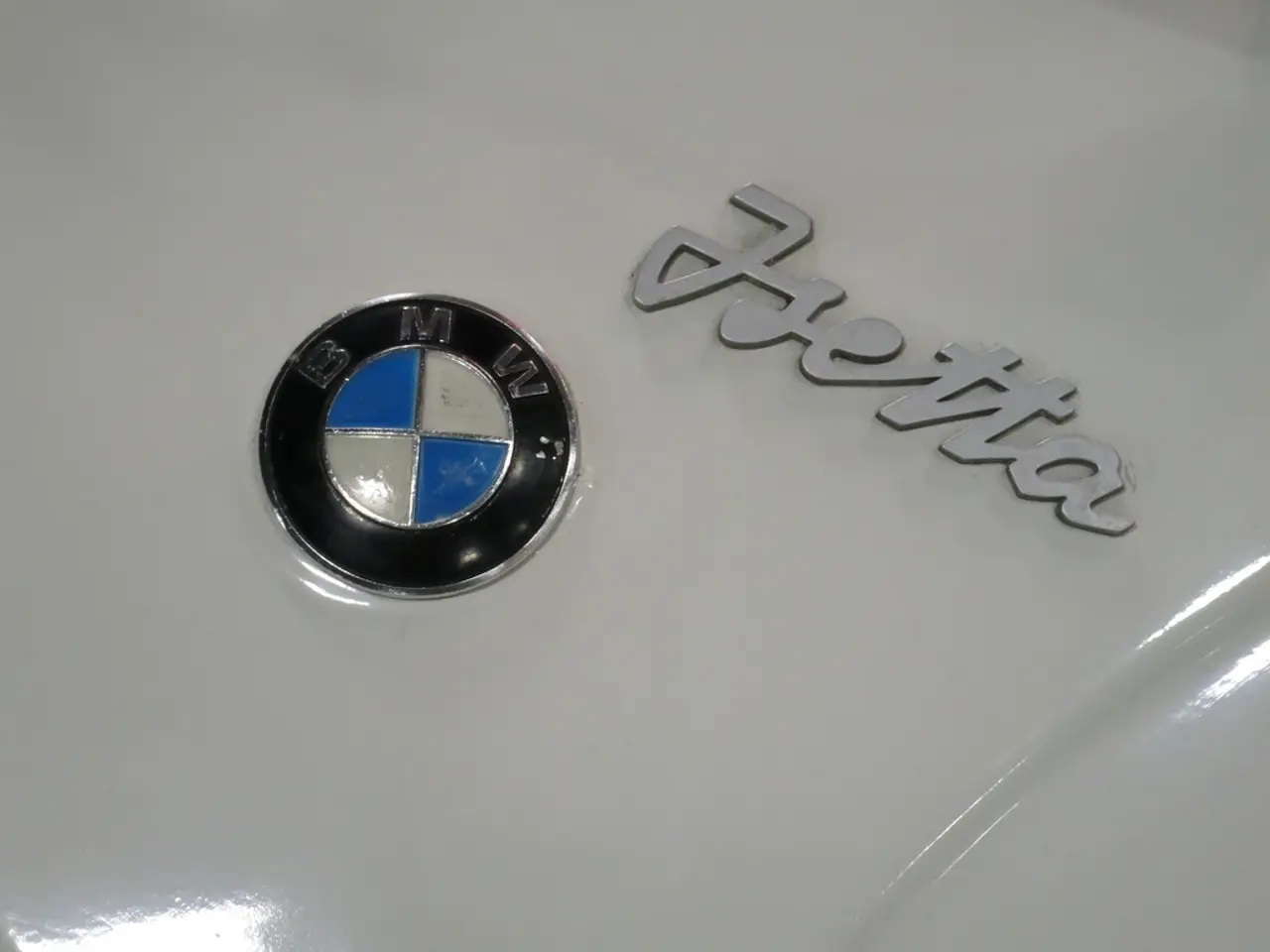 This picture shows a car bonnet with a emblem and text on it.