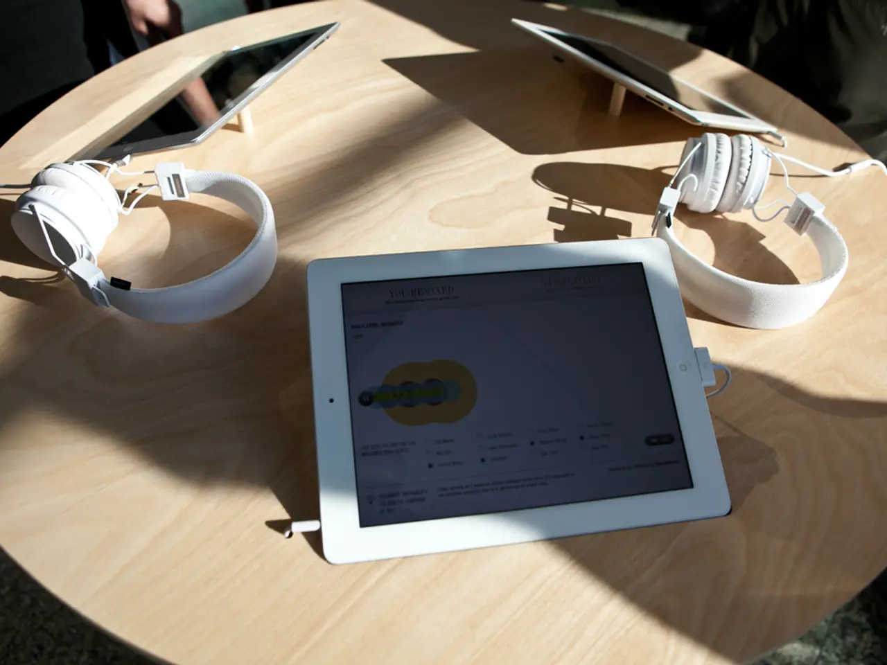 There is a table. There is a i pad and head phone on a table.