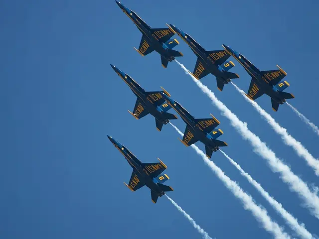 In this image we can see many aircrafts. There is some text on the aircrafts. There is a smoke in...