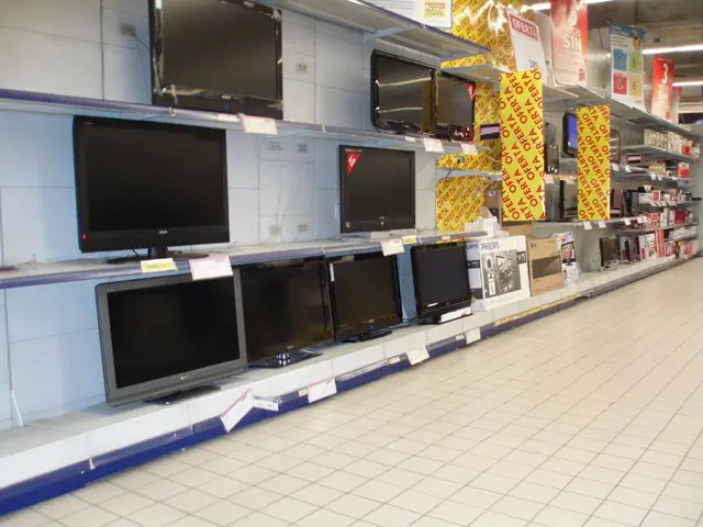 In this picture I can see there are televisions arranged in the shelves and there are other boxes...