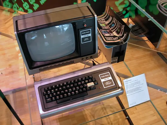 In this image I can see the system on the glass table. In-front of the system I can see the board....