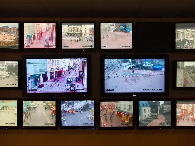 In this image we can see few televisions on the wall.