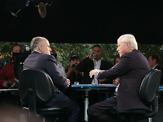 In the image we can see there are people who are sitting on chair and the chairs are in black...