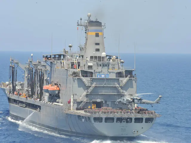 In this image, I can see a helicopter flying and there is a ship on the water. In the background,...