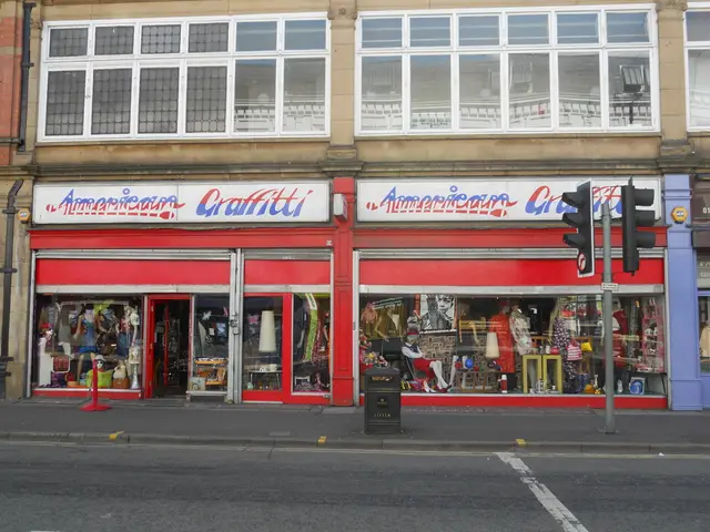 In this picture we can see a building, boards, mannequins, glasses, bin, pole, and traffic signals....