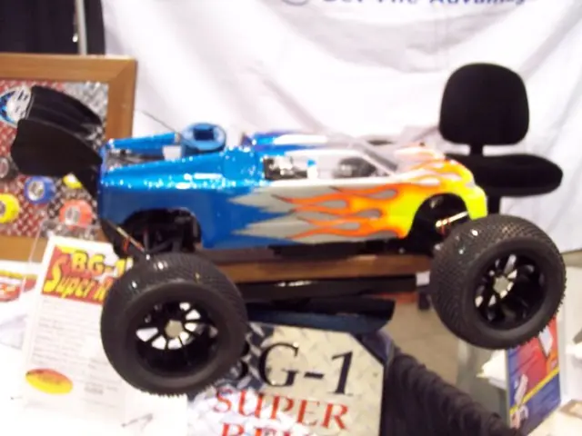 In this image I can see a toy vehicle in blue,yellow,white and orange color. I can see few...